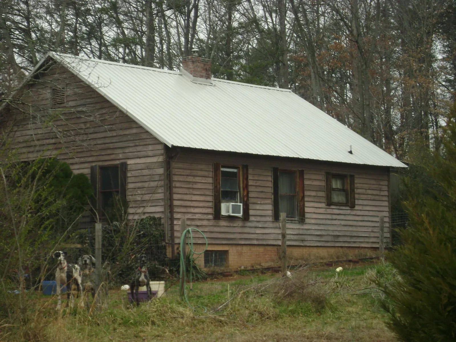 White metal roof on an old wood sided farmhouse, from a Metal Roof Installation job in Britton